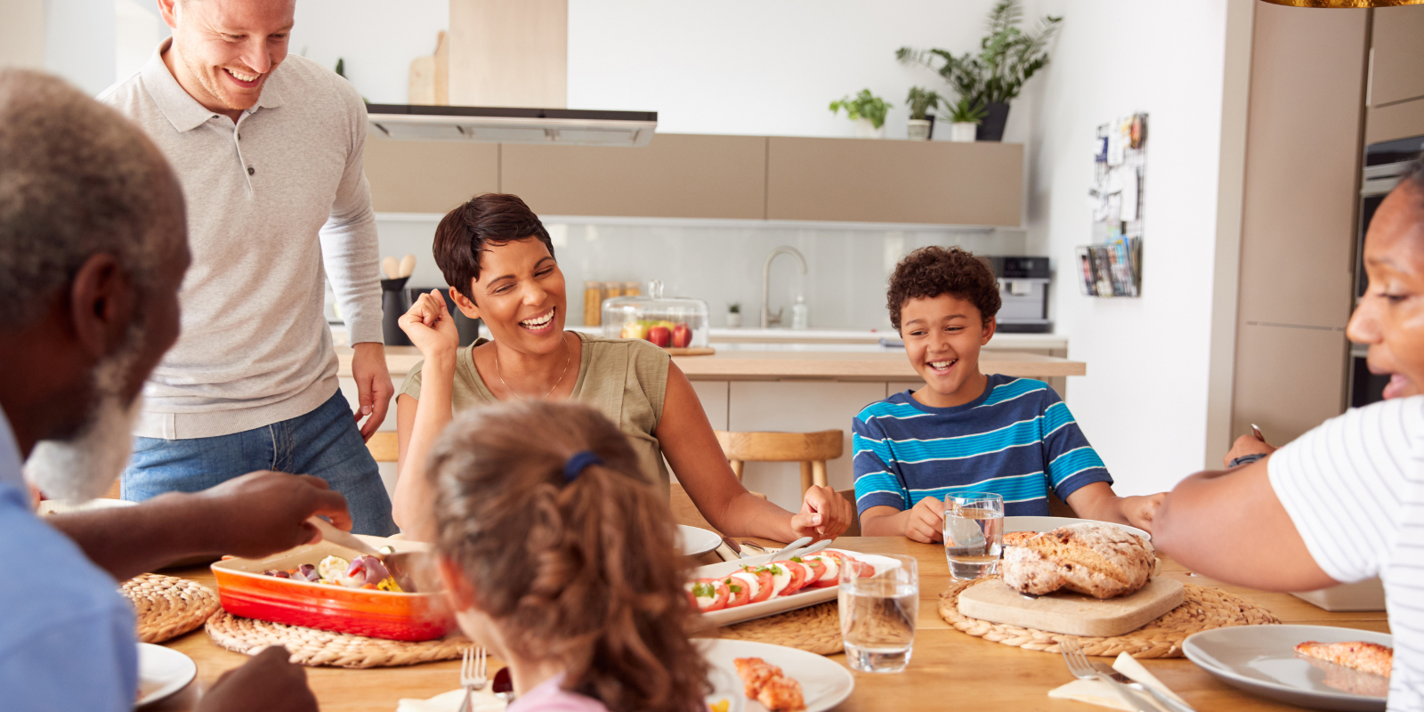 Family disconnecting from electronic devices and connecting over dinner. 